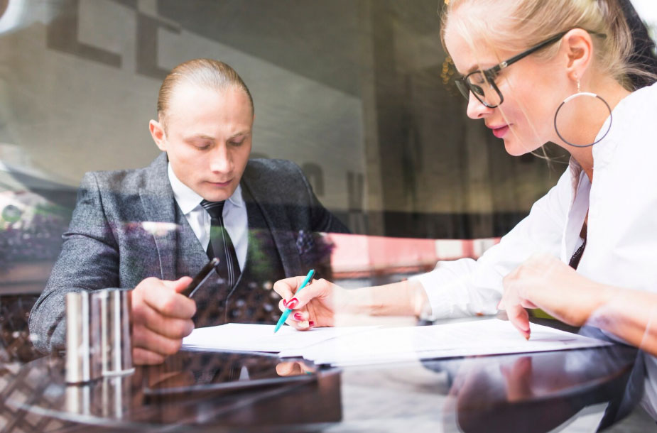 Two businesspeople examining document