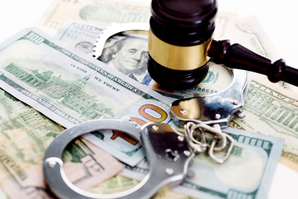 judges gavel and handcuffs on american dollar bills